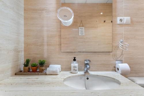 a bathroom with a sink and a mirror at Beach Center Only 150 M Luxury in Fuengirola