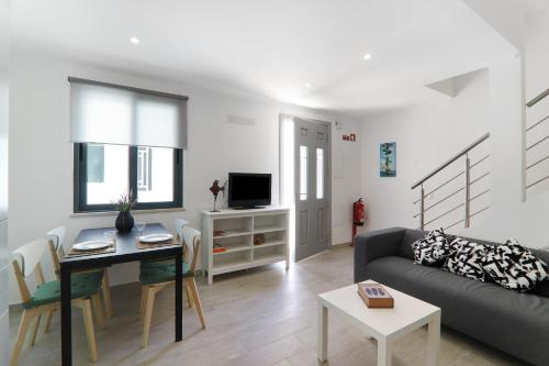 a living room with a couch and a table at Casa Lopes in Fuzeta