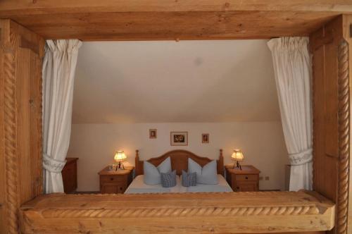 a large bedroom with a large bed with blue pillows at Landhaus Reiser in Grainau
