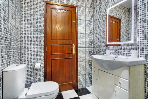 a bathroom with a toilet and a sink and a mirror at Pico The Best View in Ribeira Brava