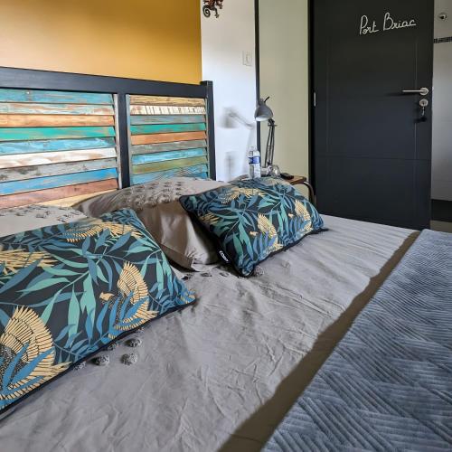 a bed with two pillows on top of it at La Fée Maison, chambres d'hôtes in Plouër-sur-Rance