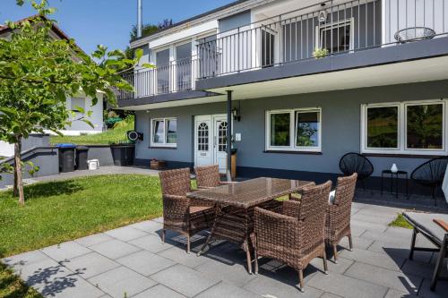 a patio with a table and chairs in front of a house at Haus Albi in Waldkirch