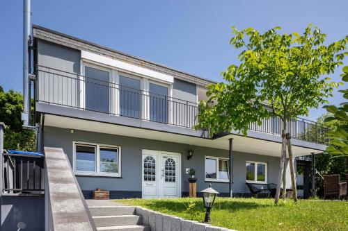 a house with a balcony on top of it at Haus Albi in Waldkirch