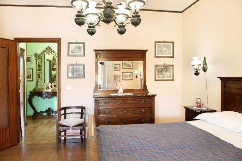a bedroom with a bed and a dresser and a mirror at Appartamento Iris in Cisterna dʼAsti