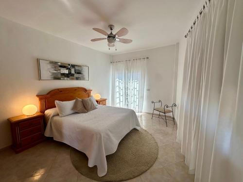 a bedroom with a bed and a ceiling fan at Casa Alba in Lomo de Arico