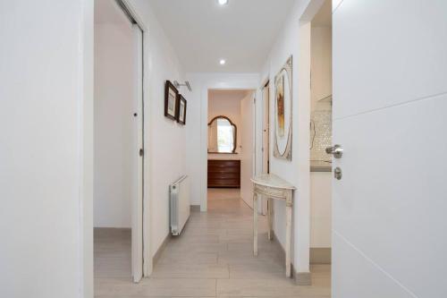 a hallway with white walls and a sink in a room at Ethel in Castelldefels