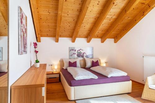a bedroom with a bed and a wooden ceiling at Bletschers Hoamat in Mittenwald