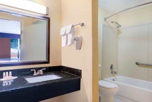 A bathroom at Days Inn by Wyndham Knoxville East