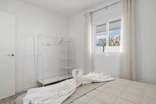 a white bedroom with a glass shower and a bed at Villa Laruma in Cádiz
