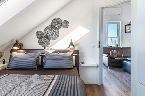 a bedroom with a bed and a living room at Ferienwohnung Romanas in Ostrach