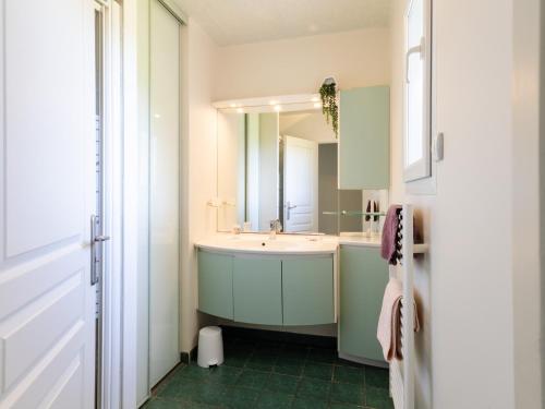 a bathroom with a sink and a mirror at Gîte Pors Mabo in Trébeurden
