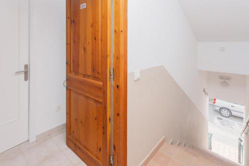 a wooden door in a room with a white wall at Cala'n Blanes Park 228 in Cala en Blanes