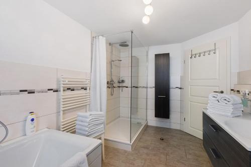 a white bathroom with a shower and a sink at Reiselust in Stockach