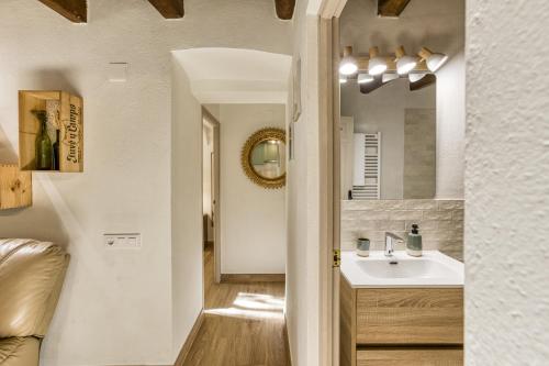 a bathroom with a sink and a mirror at El Celler - Can Bonet in Sant Martí Vell