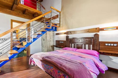 a bedroom with a bed and a staircase at C de Alborada del eo in Villameitide