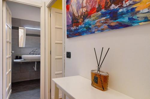 a bathroom with a sink and a painting on the wall at Casa Sole e Mare in Arenzano