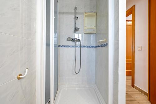 a bathroom with a shower with a tub at Ca La Lola in Llorenç del Penedes