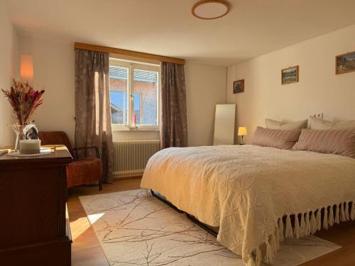 a bedroom with a large bed and a window at Central Home in Krumbach in Krumbach