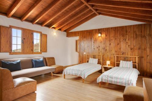 a living room with two beds and a couch at Mirador de la Abuela in Gáldar