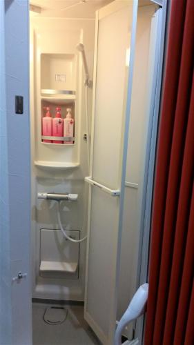 a refrigerator with a door open in a bathroom at Naoshima Kowloon in Naoshima