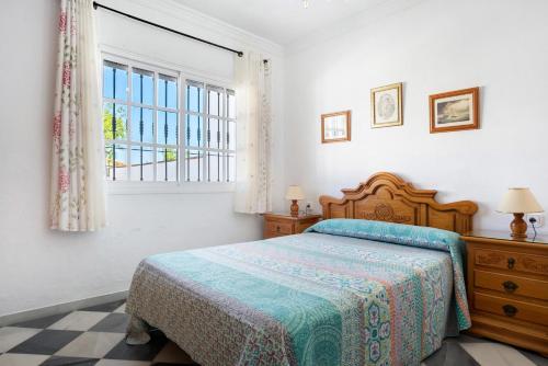 a bedroom with a bed and a window at Villa Carmen in Hozanejos