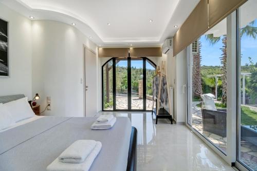 a bedroom with a bed with two towels on it at Goudis Villa Thanasis in Lefkada