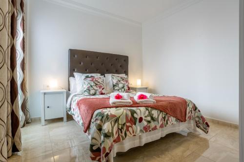 a bedroom with a bed with two pillows on it at Apartamento Rolycar 202 in Icod de los Vinos