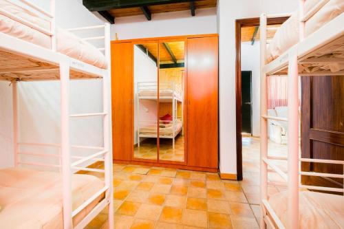 a room with bunk beds and a hallway with a doorway at El Paraíso Del Olivar in Bollullos de la Mitación
