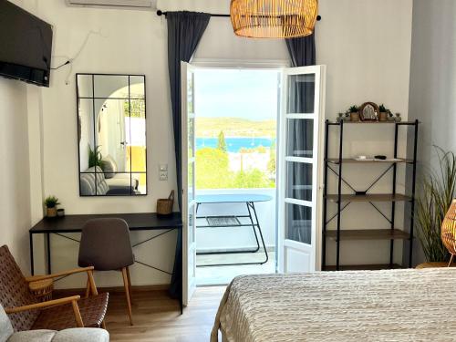 a bedroom with a bed and a desk and a window at aeolian blu 7 in Parikia