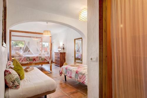 a bedroom with two beds and a mirror at Casa Ohanna in Vejer de la Frontera