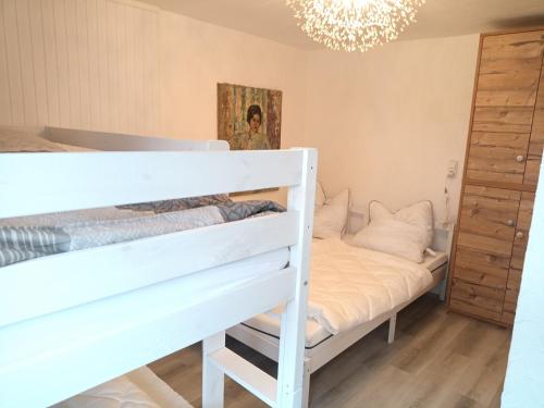 a bedroom with a bunk bed and a chandelier at Kinderfreundlich Am Dorflädchen in Blankenheim