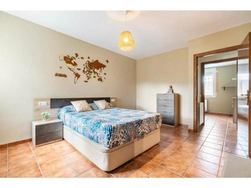 a bedroom with a bed with a map on the wall at Ca La Cuca in Alforja