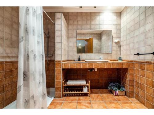a bathroom with a sink and a mirror at Ca La Cuca in Alforja