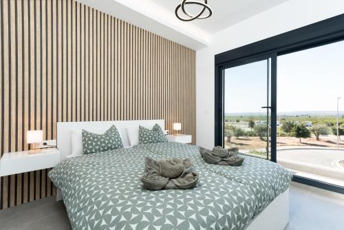 a bedroom with a bed and a large window at R-40-B Luxury Villa with pool in Los Montesinos