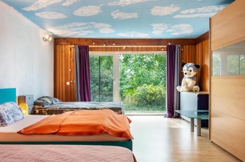 a bedroom with a bed and a teddy bear on the ceiling at Ferienwohnung Brenda in Schillingsfürst