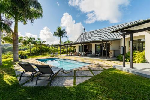 an exterior view of a house with a swimming pool at Villa Kamaya, Chamarel in Chamarel