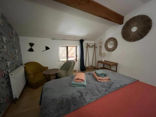 a bedroom with a bed and a chair and a mirror at Chambre d'hôte Léontine in Lamagistère