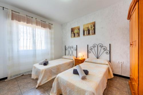 a room with two beds and a window at Nazareno in Níjar