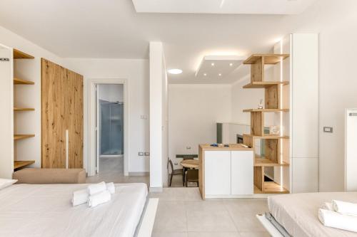 a bedroom with two beds and a desk in it at Appartamenti a 50 m dal mare in Torre San Giovanni Ugento