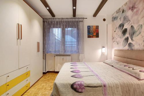 a bedroom with a bed and a window at Maison de Doi - Chatillon in Châtillon