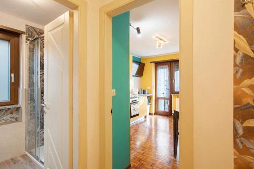 a kitchen with yellow and green walls at Maison de Doi - Chatillon in Châtillon