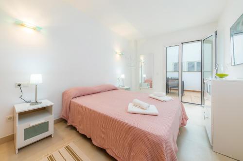 a bedroom with a bed with two towels on it at Piso Claudia in Port de Pollensa