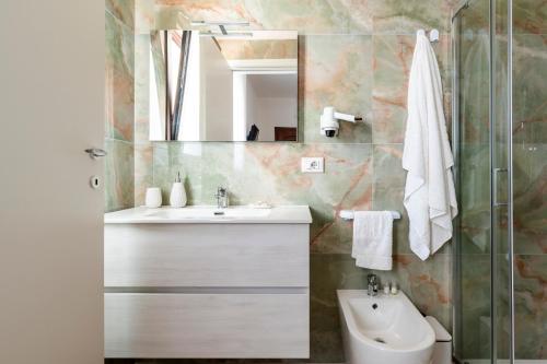 a bathroom with a sink and a mirror at Quintessenza – Boutique Rooms in Leverano
