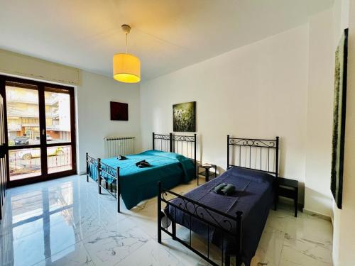 a bedroom with two beds in a room at - The White Marble Beach Housefree in Marina di Carrara