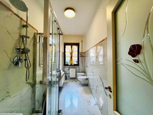a bathroom with a shower and a toilet and a sink at - The White Marble Beach Housefree in Marina di Carrara