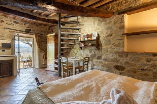 a bedroom with a bed and a table in a room at Camera con Vista in Anghiari