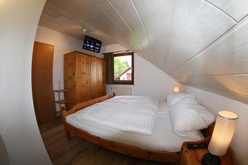 a bedroom with a bed in a small room at Ferienhaus Da Vinci in Kirchheim