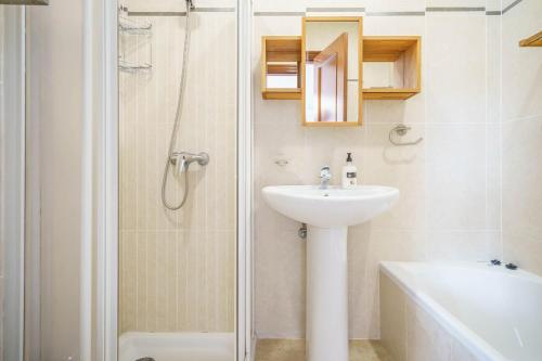 a bathroom with a sink and a shower at Mediterranean Vacation in Mallorca in Cala Pi