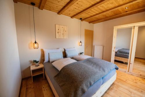 a bedroom with a large bed in a room at Apartment Judith - Gallhof in Vollan