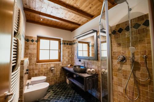a bathroom with a sink and a shower at Apartment Judith - Gallhof in Vollan